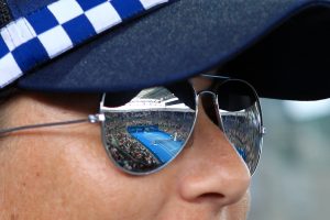 A Police Officer watching the crowds inside Pat Rafter Arena.