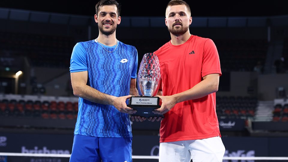 Julian Cash and Lloyd Glasspool with the trophy after winning the men's doubles final against Jiri Lehecka and Jakub Mensik at the 2025 Brisbane International. Photo: Getty Images